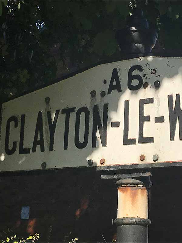 a road sign displaying Clayton-le-Woods